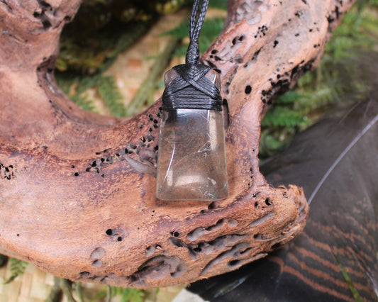 Toki pendant carved from Smokey Quartz