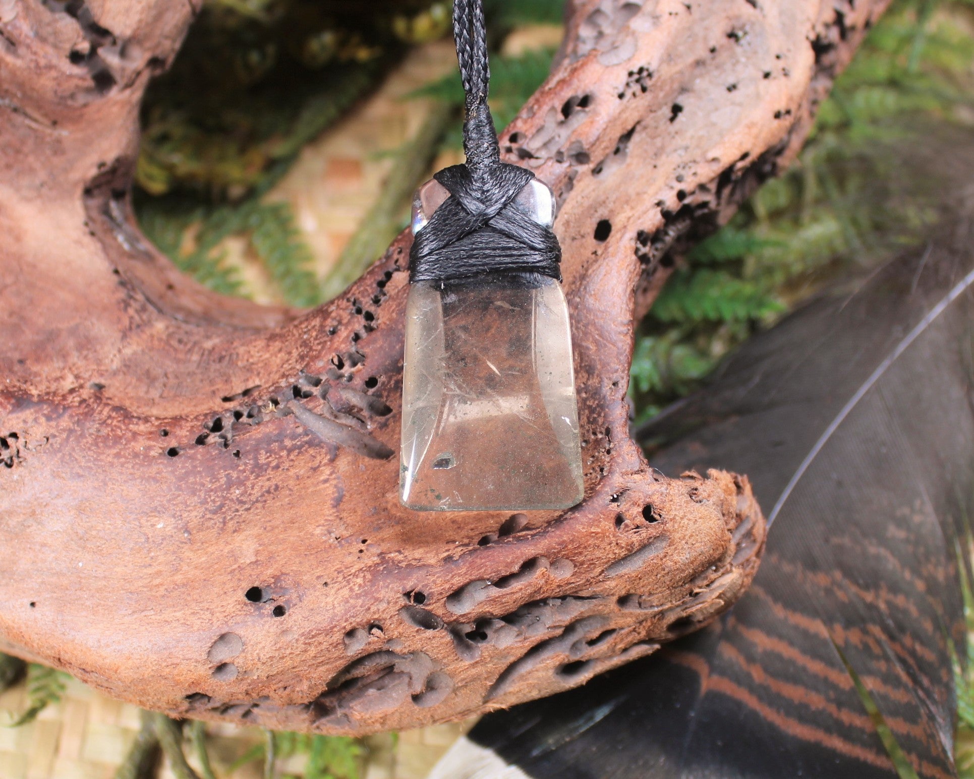Toki pendant carved from Smokey Quartz