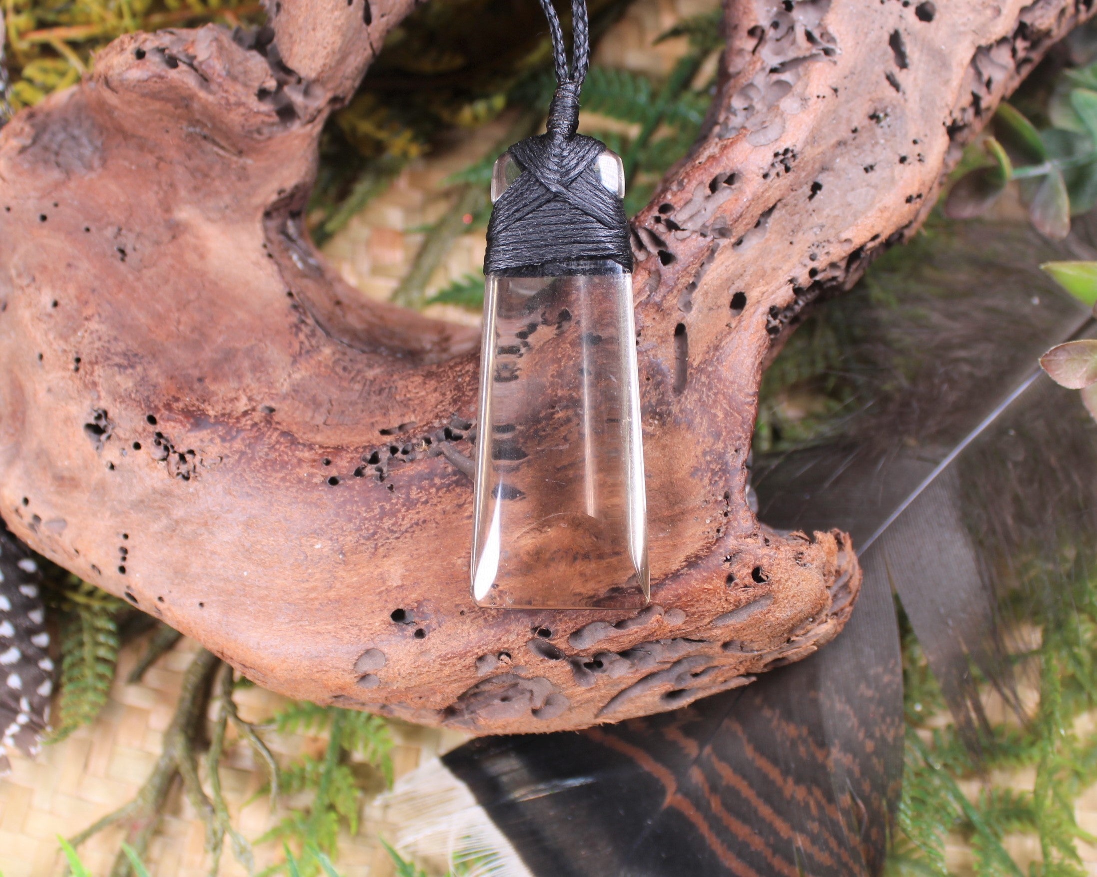 Toki pendant carved from Smokey Quartz