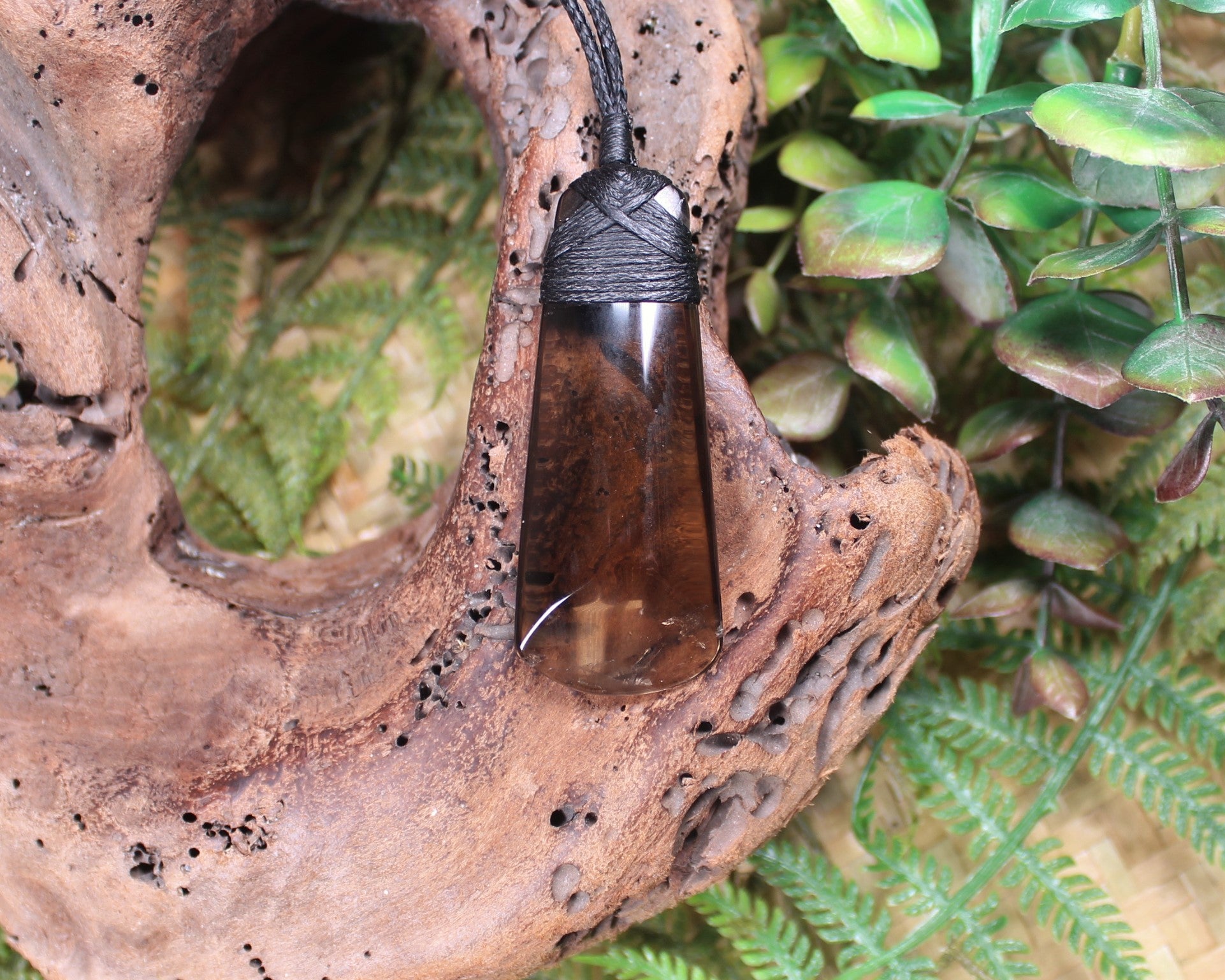 Toki pendant carved from Smokey Quartz