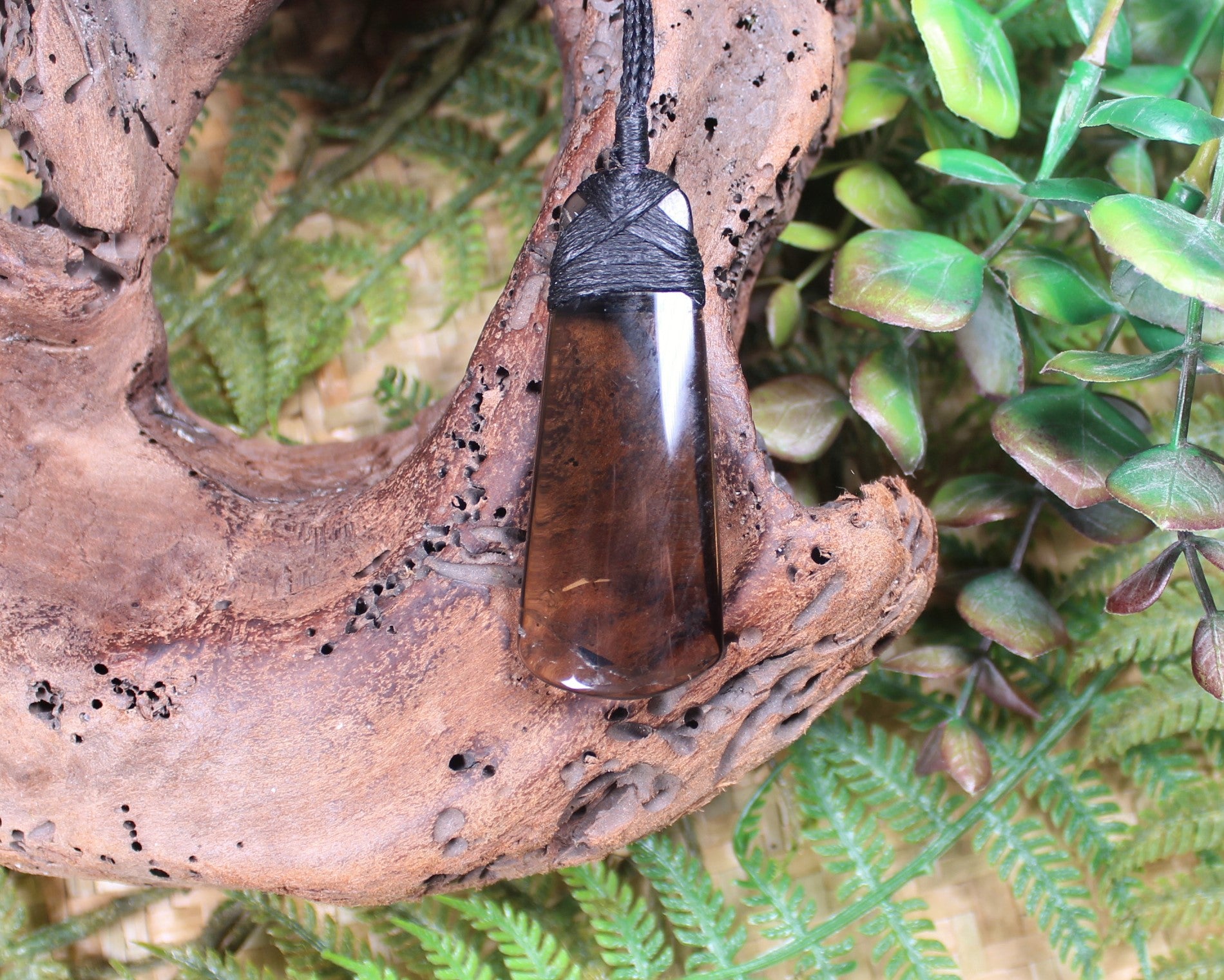 Toki pendant carved from Smokey Quartz