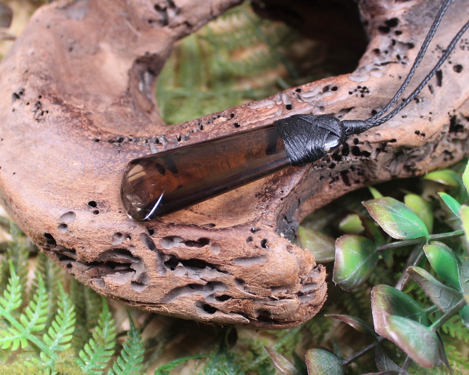 Toki pendant carved from Smokey Quartz