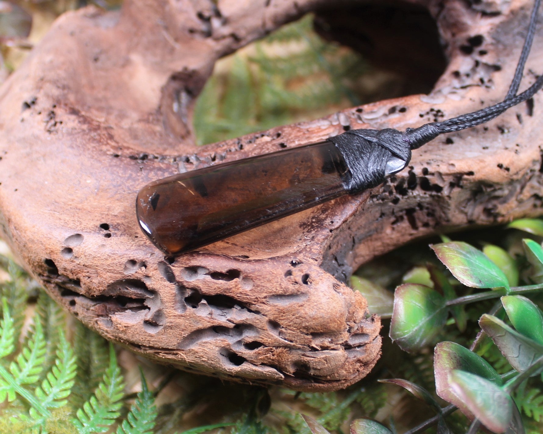 Toki pendant carved from Smokey Quartz