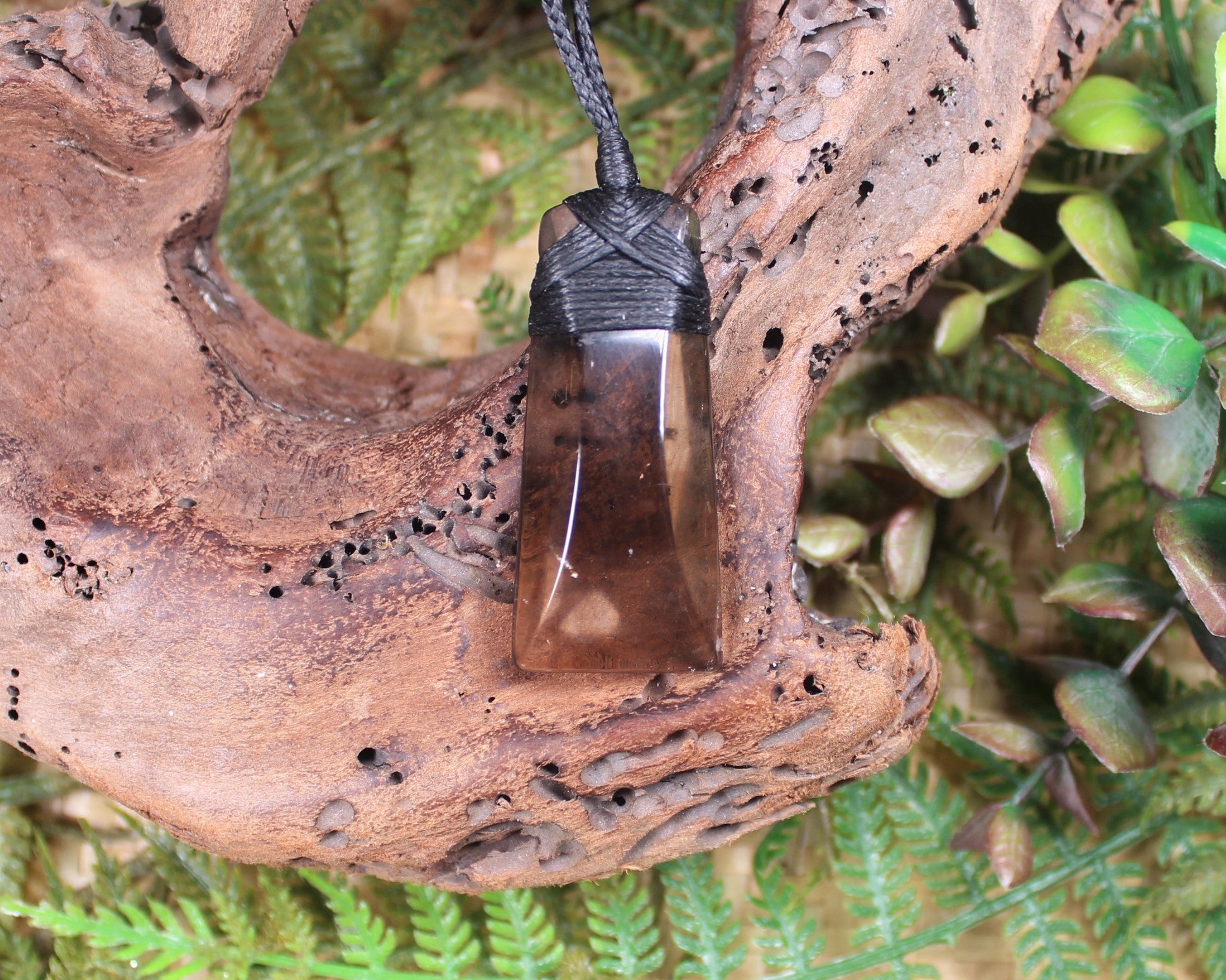 Toki pendant carved from Smokey Quartz