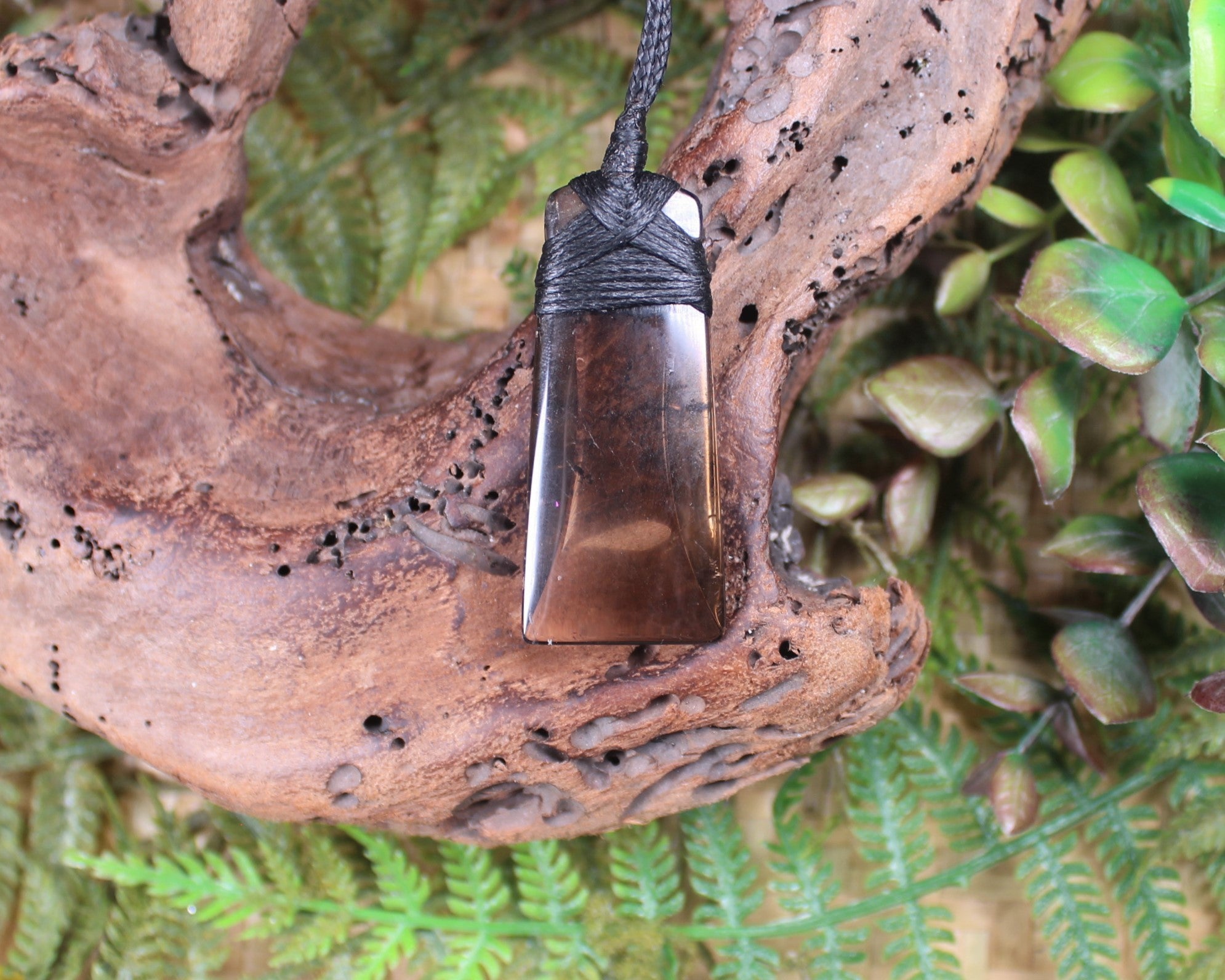 Toki pendant carved from Smokey Quartz