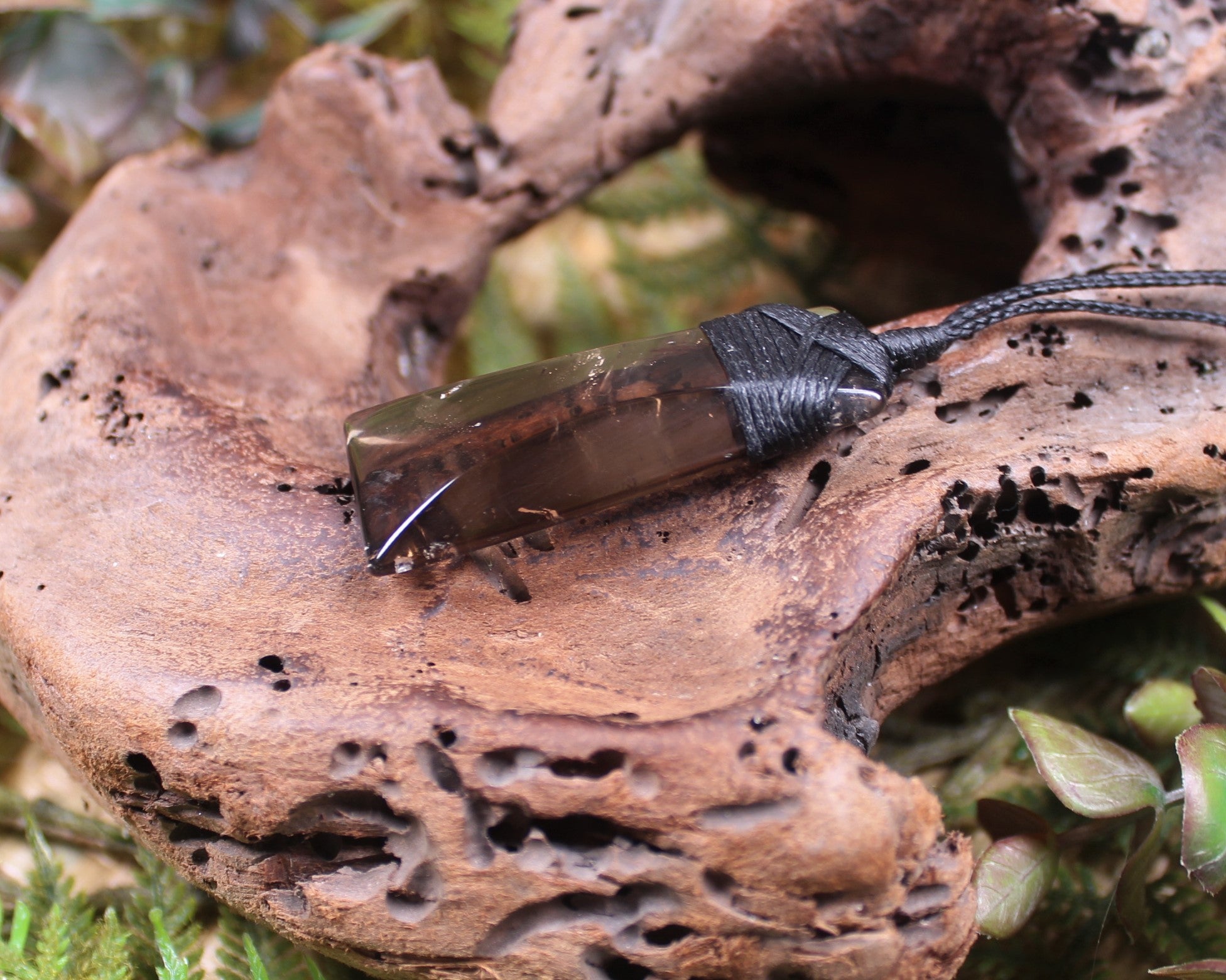 Toki pendant carved from Smokey Quartz