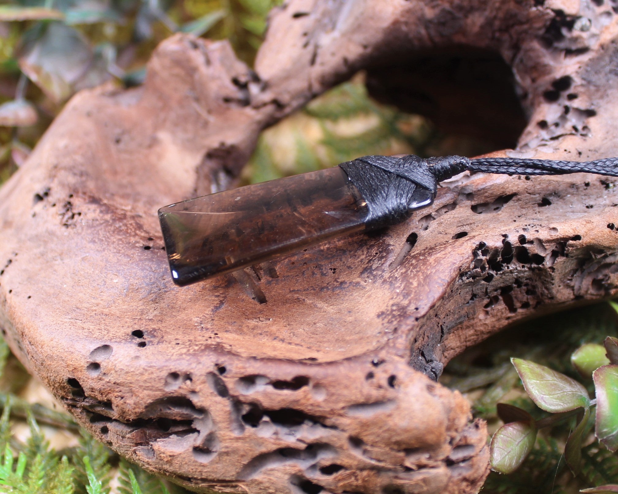 Toki pendant carved from Smokey Quartz