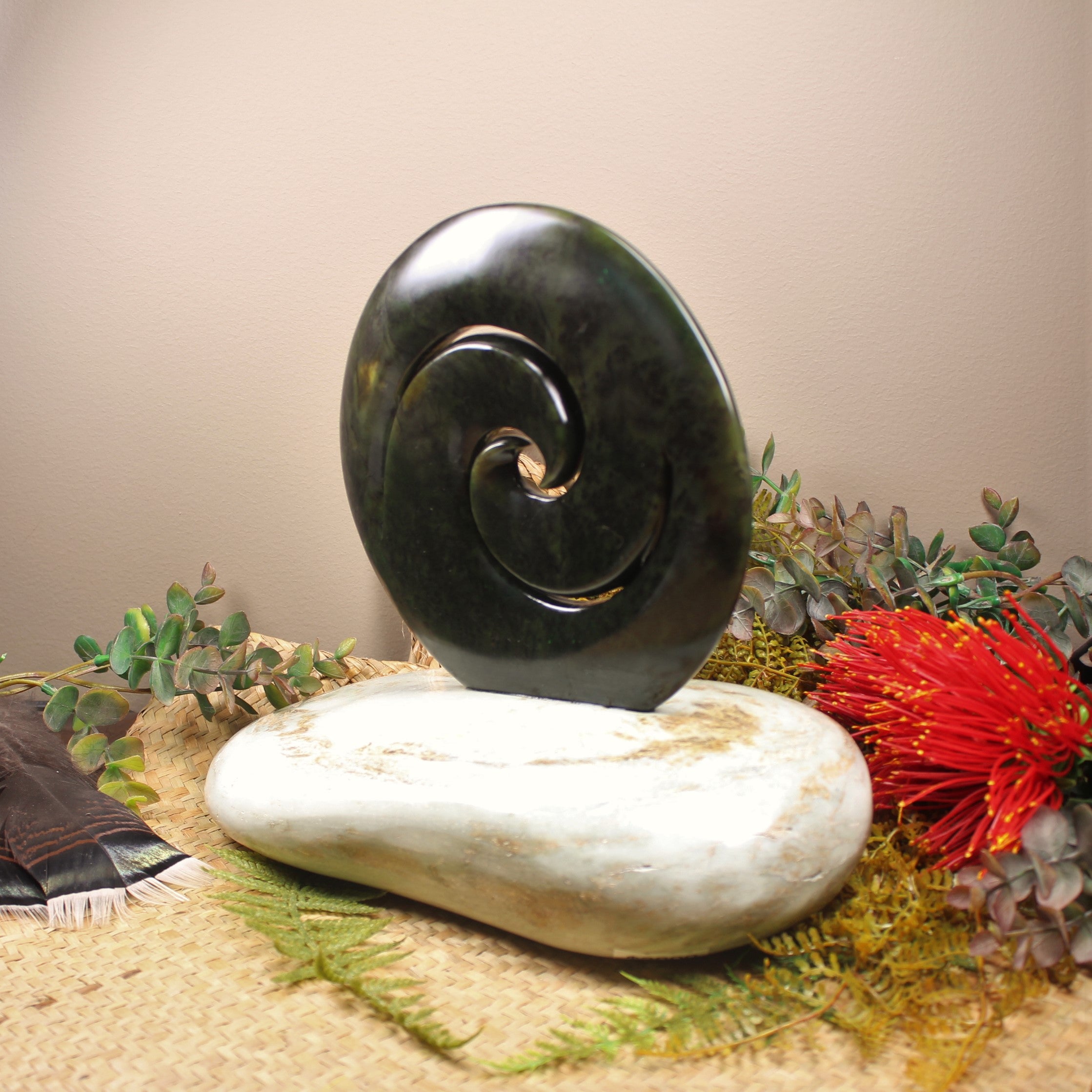 Koru sculpture carved from Rimu Pounamu and set on a Serpentine base - NZ Greenstone